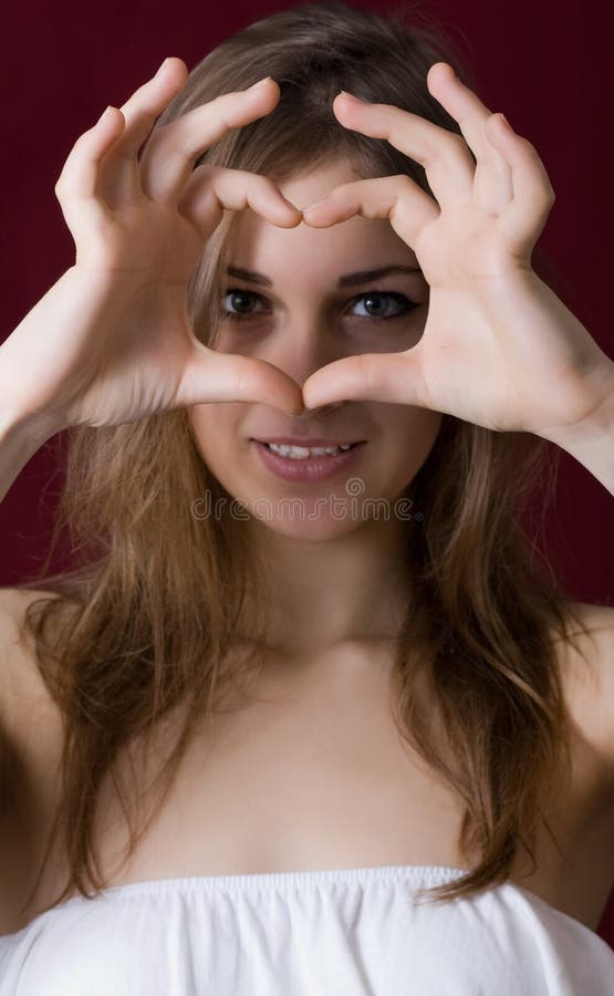 Beautiful girl show love sign