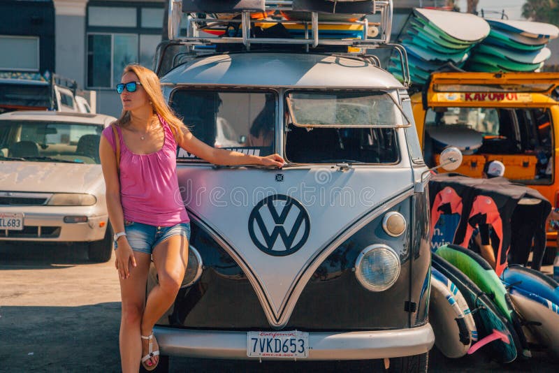 Beautiful girl standing by the VW hippy