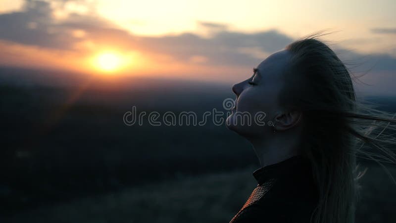 Beautiful girl on the sunset background