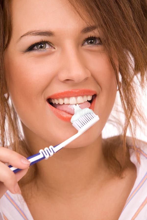 Beautiful girl with tooth-brush isolated on white