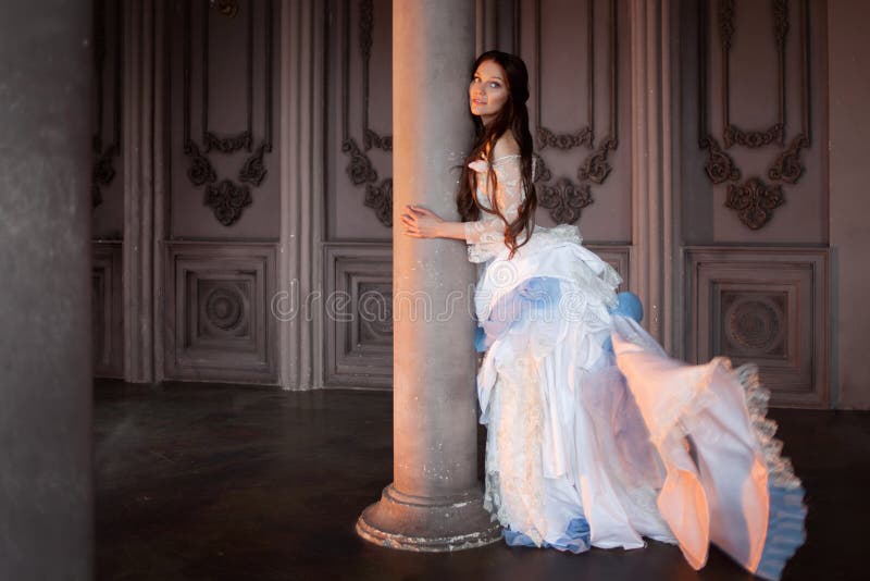 Beautiful girl in a vintage dress, in gloomy interior, Gothic and fairy tale royalty free stock images Beautiful girl in a vintage dress, in gloomy interior, Gothic and fairy tale royalty free stock images