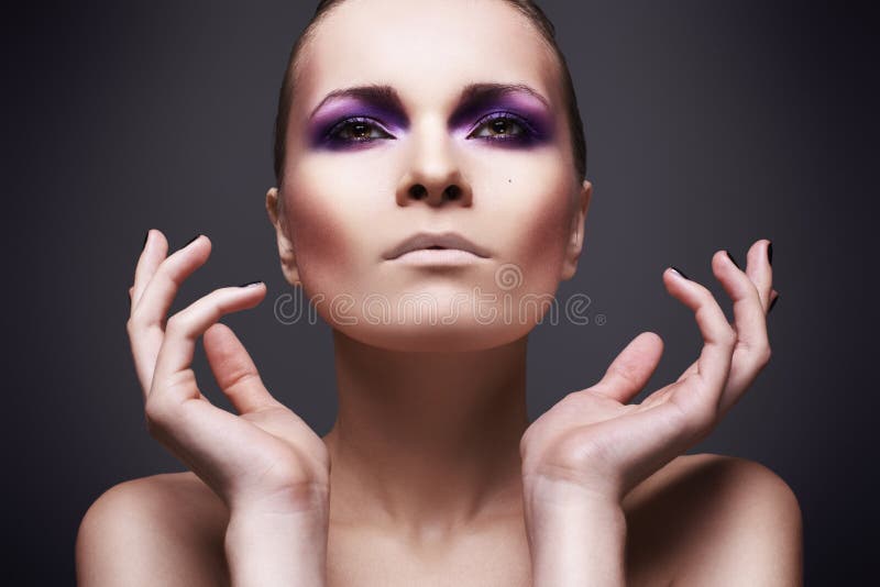 Beautiful girl with violet make-up