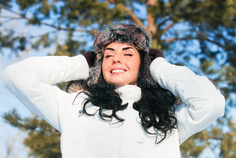 Beautiful girl on a walk in a winter park