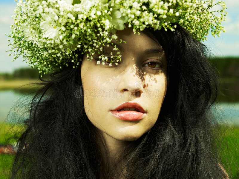 Beautiful girl wearing a wreath of wildflowers