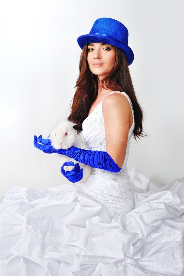 Beautiful girl in a white dress in a blue hat stock photo Beautiful girl in a white dress in a blue hat stock photo