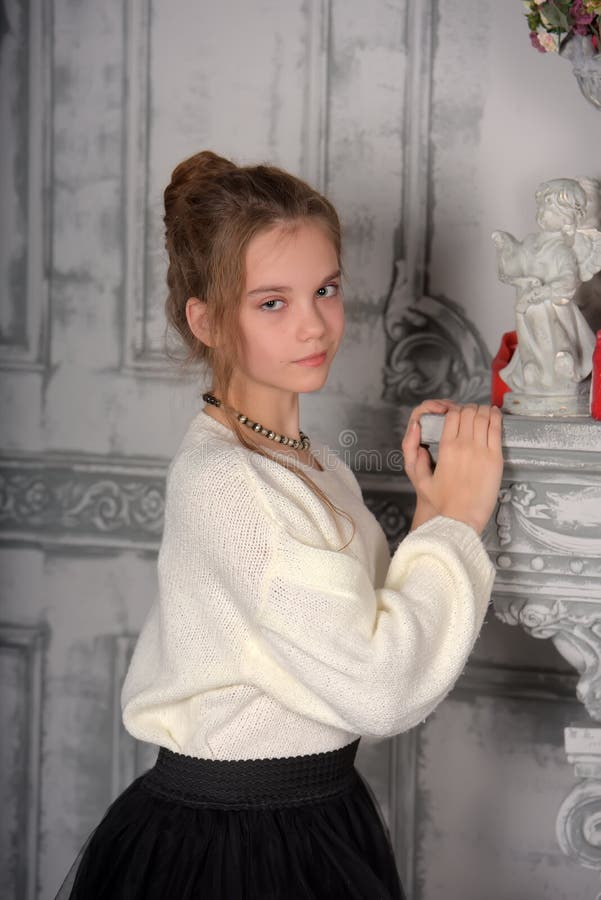 Beautiful Girl In A White Sweater With A High Hairdo Stock Image