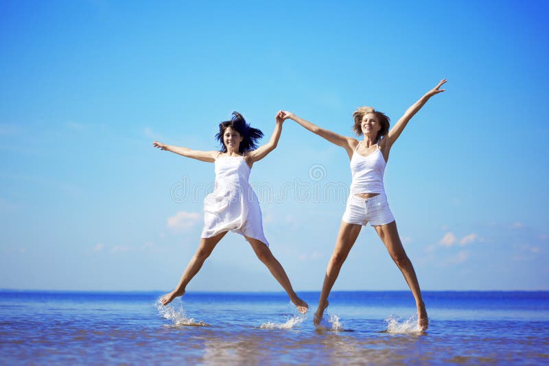 Beautiful girl who jump on the beach