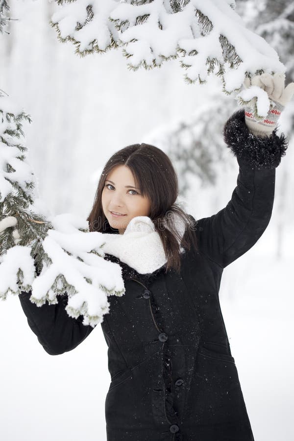 Beautiful girl in winter forest royalty free stock images