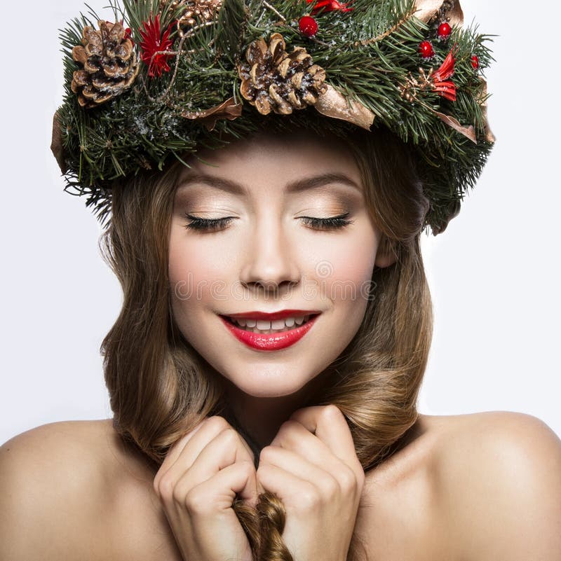 Beautiful Girl with a Wreath of Christmas Tree Branches and Cones. New ...