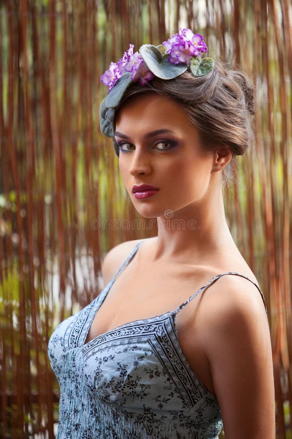 Beautiful girl with a wreath of flowers