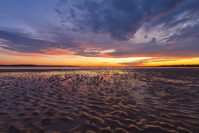 Beautiful glowing sunset reflections in sand ripples, Inverloch, Australia royalty free stock images Beautiful glowing sunset reflections in sand ripples, Inverloch, Australia royalty free stock images
