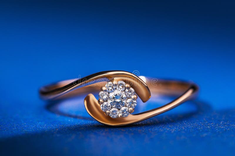 Beautiful gold ring with precious stones on a blue background royalty free stock photos Beautiful gold ring with precious stones on a blue background royalty free stock photos