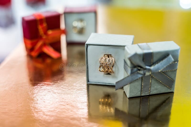 Beautiful Golden Jewellery In Gift Box On Golden Background Stock Image
