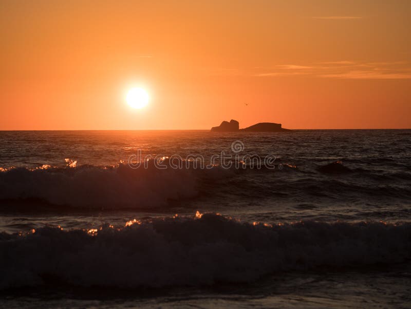 Beautiful golden sunset on ocean with waves in foreground stock image Beautiful golden sunset on ocean with waves in foreground stock image