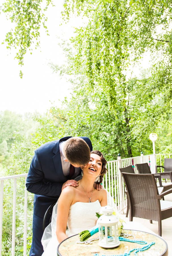Beautiful gorgeous bride and stylish groom on the restaurant terrace royalty free stock photos