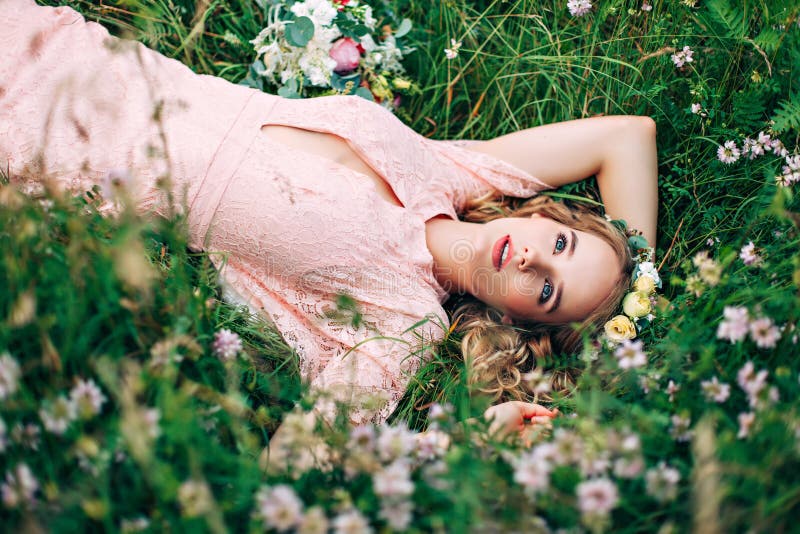 Beautiful And Happy Bride Lying In The Garden