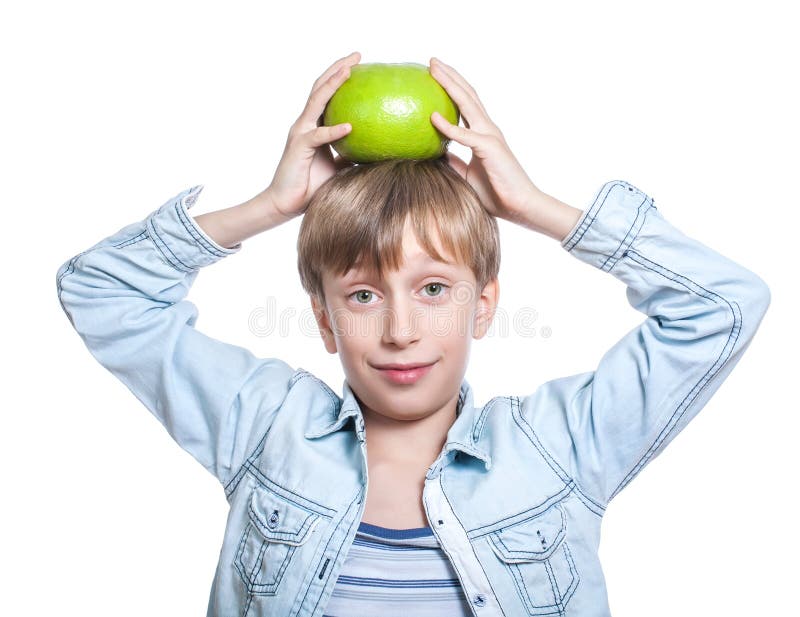 Beautiful happy child in stylish shirt shows a big grapefruit holding it on his head smiling stock image Beautiful happy child in stylish shirt shows a big grapefruit holding it on his head smiling stock image