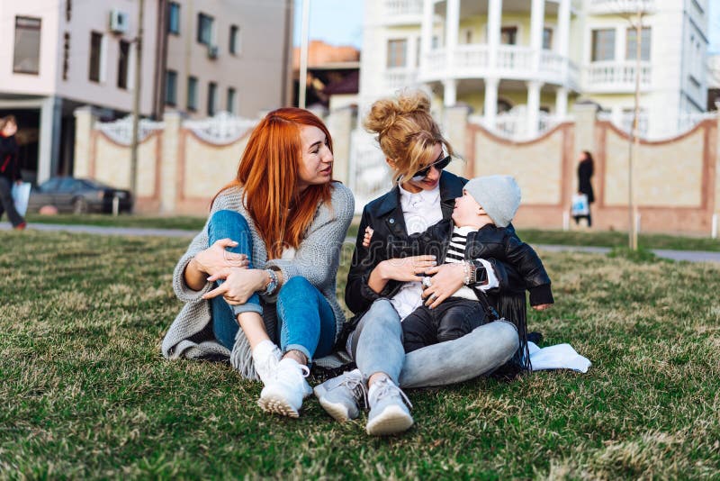 Mom and aunt play with a boy in the Park stock images Mom and aunt play with a boy in the Park stock images