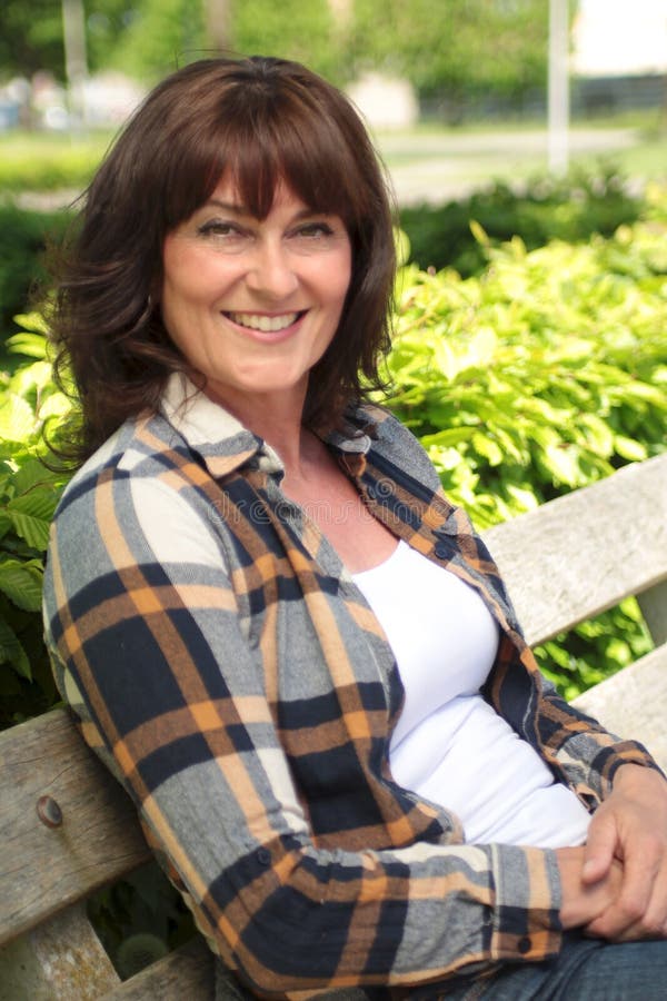 Beautiful Happy Mature Caucasian Woman Outside In The Park Stock Image