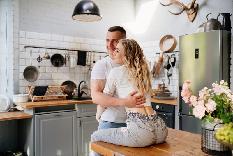 The Lovers Getting Hot In The Kitchen Pair of Lovers Kissing and Hugging in Kitchen Next To the Refrigerator