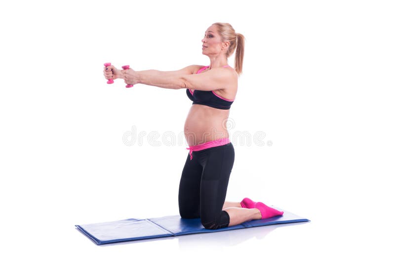 Beautiful happy pregnant women doing exercise with dumbbells on the white background