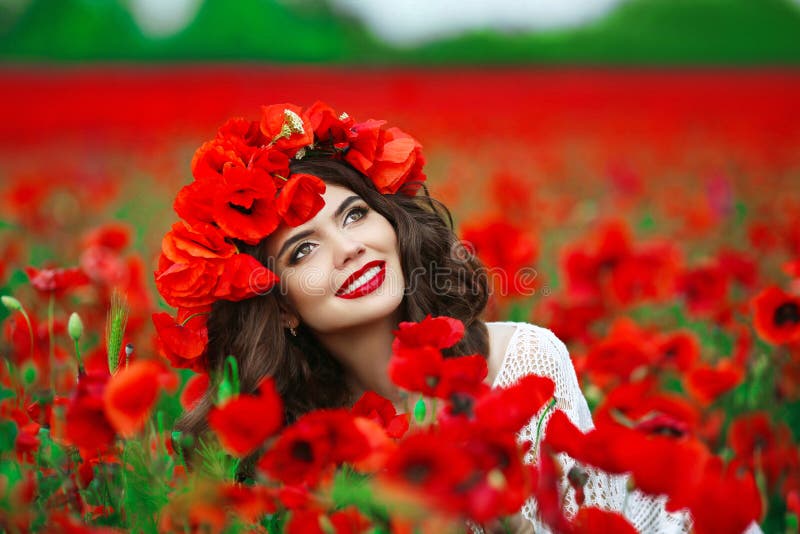 Beautiful happy smiling teen girl portrait with red flowers on h