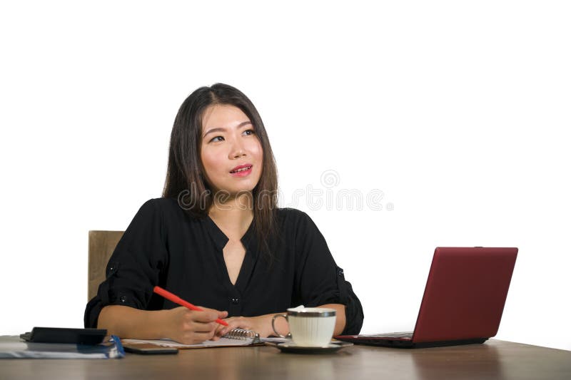 Beautiful and happy successful Asian Chinese business woman working relaxed at office computer desk smiling thoughtful and sweet i royalty free stock photography Beautiful and happy successful Asian Chinese business woman working relaxed at office computer desk smiling thoughtful and sweet i royalty free stock photography