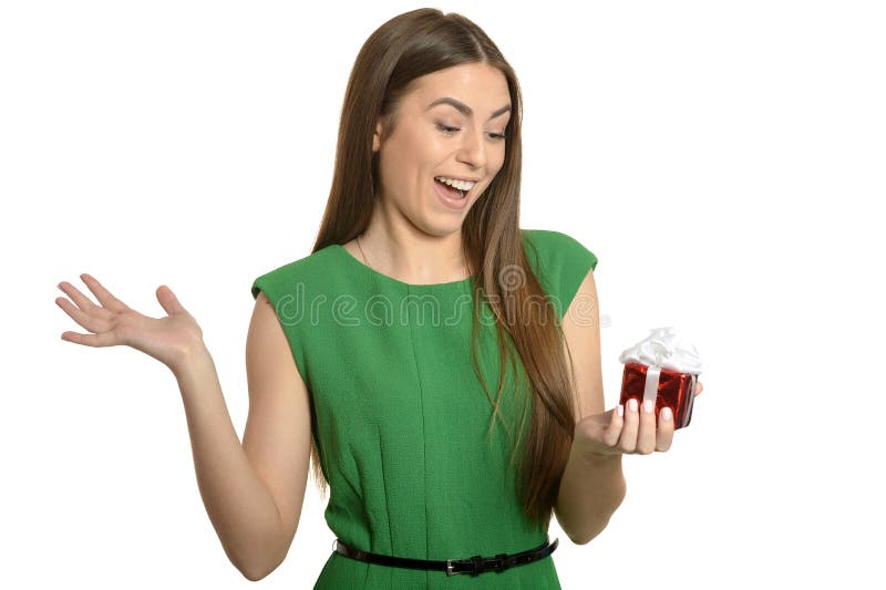 Beautiful happy woman in green dress with small gift box isolated on white background