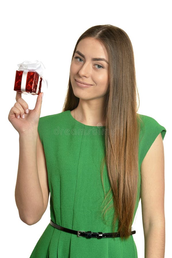 Beautiful happy woman in green dress with small gift box isolated on white background