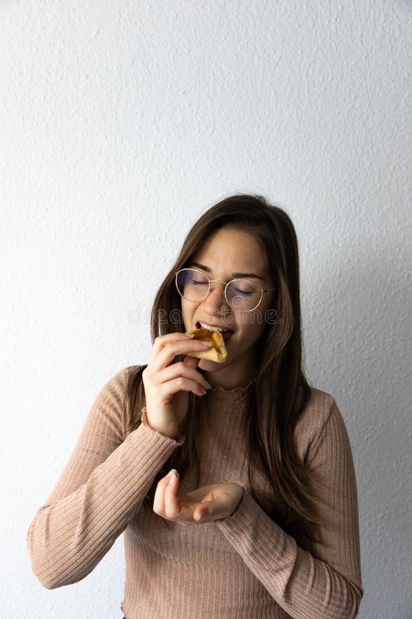 Beautiful and happy women portrait eating hamantash Purim apricot cookie royalty free stock photos Beautiful and happy women portrait eating hamantash Purim apricot cookie royalty free stock photos