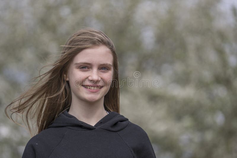 Beautiful happy young girl in nature. Close up portrait