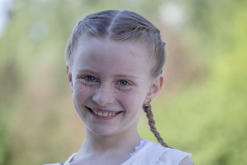 Beautiful happy young girl in nature. Close up portrait