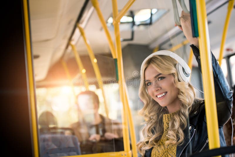 beautiful happy young woman in headphones listening music