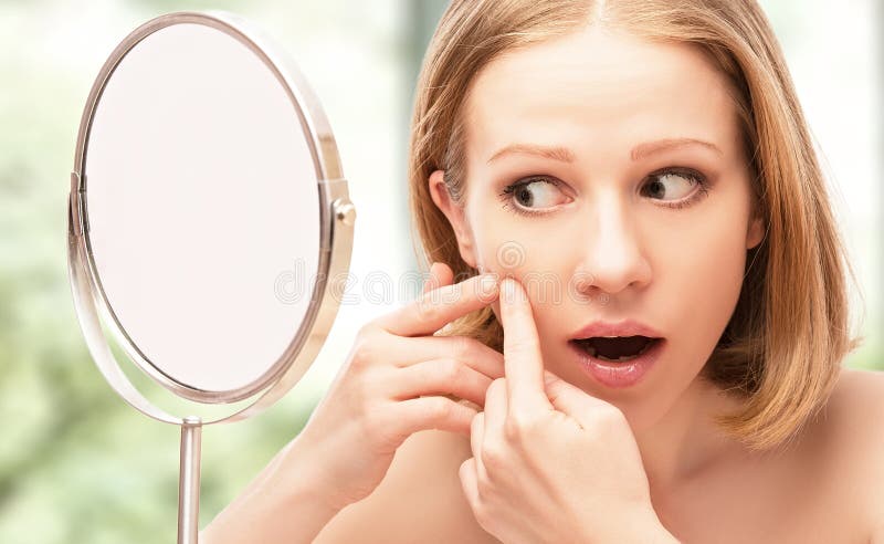 Beautiful healthy woman frightened saw in the mirror acne and w stock photo Beautiful healthy woman frightened saw in the mirror acne and w stock photo