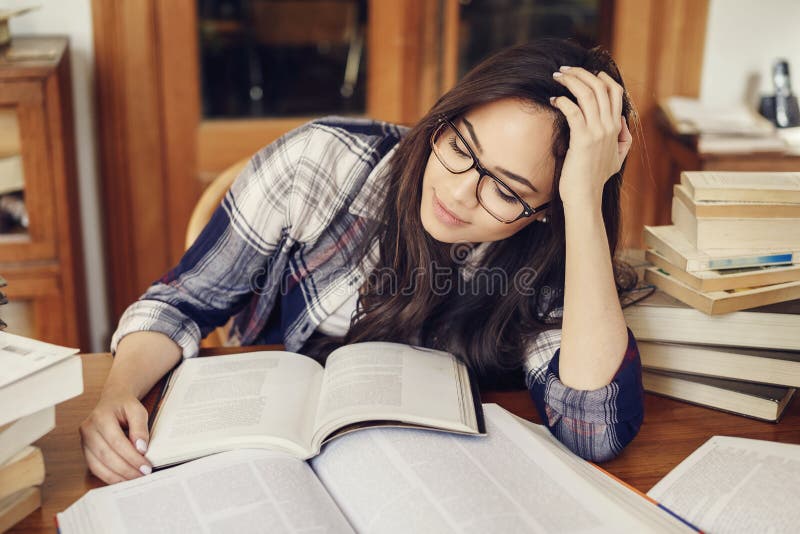Woman student reading a book very tired royalty free stock photo Woman student reading a book very tired royalty free stock photo
