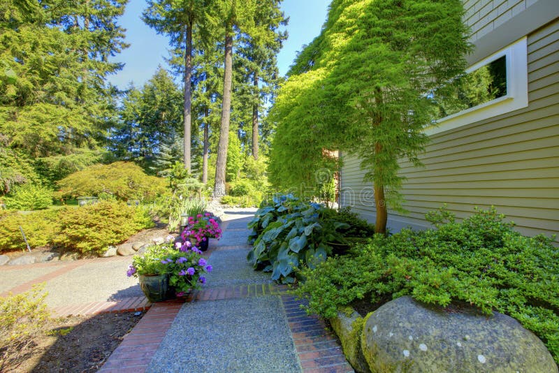 Beautiful home exterioir with brick walkway in the garden