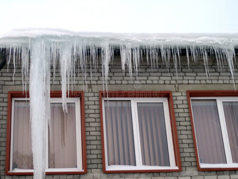 Home wall and ice icicles in winter, Lithuania stock photo Home wall and ice icicles in winter, Lithuania stock photo