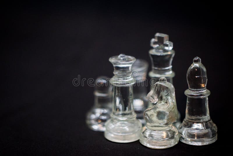 A Knight`s stand off, Icy Knight chess pieces on a black background royalty free stock image