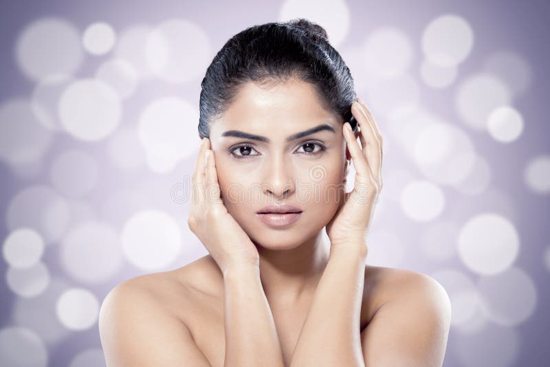 Beautiful Indian woman with healthy skin against blurred lights background. royalty free stock image Beautiful Indian woman with healthy skin against blurred lights background. royalty free stock image