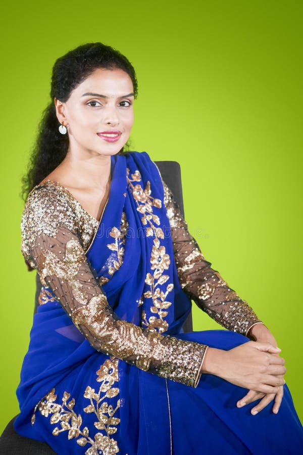 Beautiful Indian woman sitting on chair in studio stock image Beautiful Indian woman sitting on chair in studio stock image