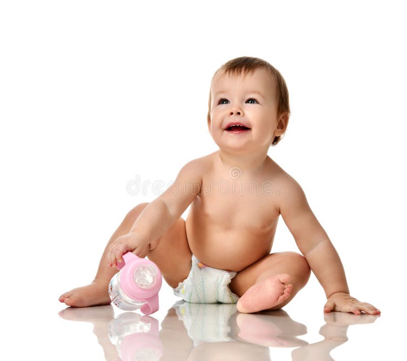 Beautiful infant baby girl toddler sitting in diaper with bottle of water