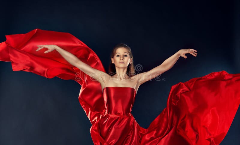 Beautiful inspirational woman dancing in a red silk dress flying stock image Beautiful inspirational woman dancing in a red silk dress flying stock image