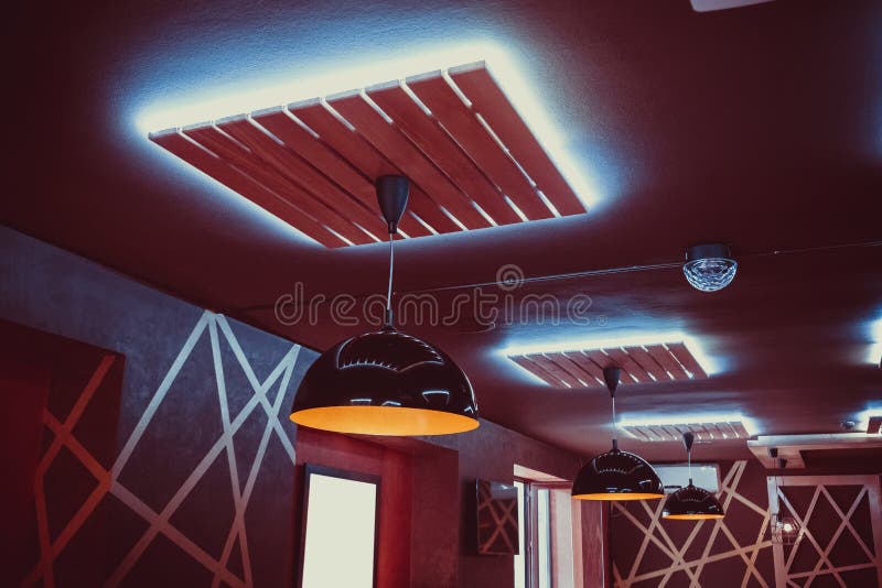 Beautiful interior restaurant with luxury chandeliers and evening lighting. Background of the ceiling lighting for party
