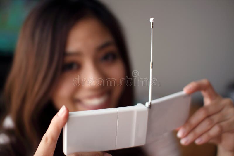 Beautiful Japanese girl with tv in a cellphone