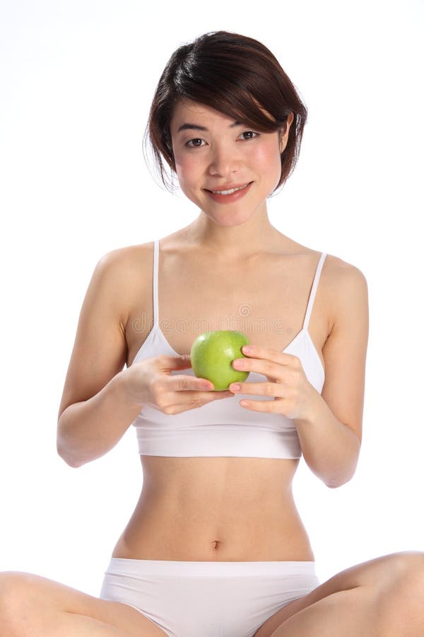 Beautiful Japanese woman sitting with an apple