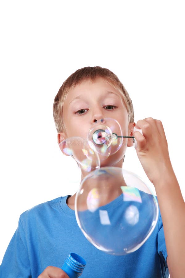 Beautiful joyful blond boy in a bright blue t-shirt blowing soap bubbles stock images Beautiful joyful blond boy in a bright blue t-shirt blowing soap bubbles stock images