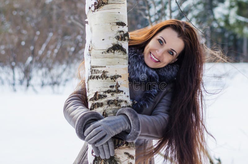 Beautiful joyful woman in winter forest