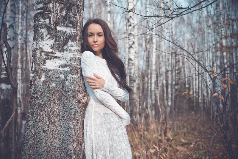 Beautiful lady in a birch forest