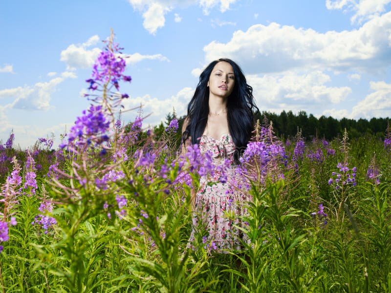 Beautiful lady in a flower meadow