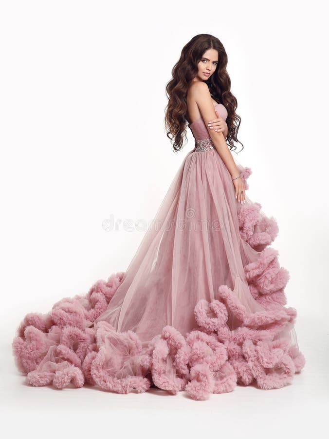 Beautiful Lady in luxury lush pink dress. Fashion brunette woman